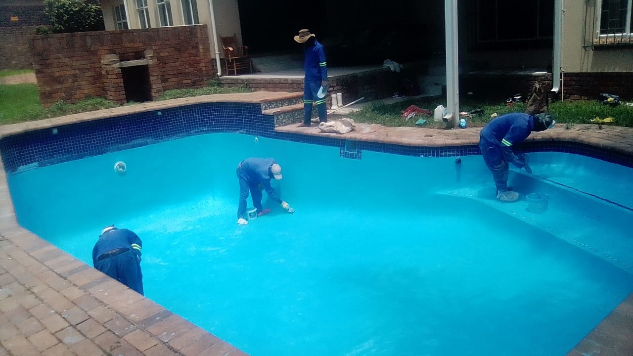 Aquarius team performing pool repairs on a damaged surface